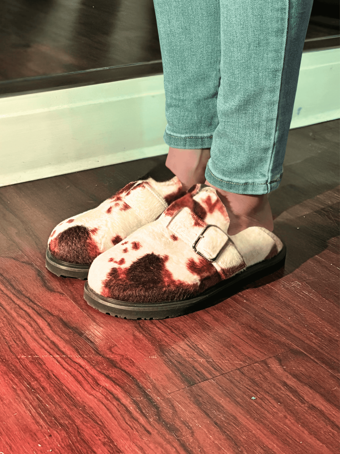 Moo Cow Print Clogs worn with jeans in front of mirrior