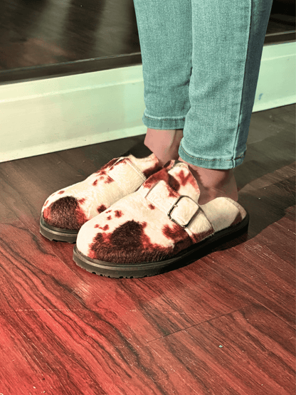Moo Cow Print Clogs worn with jeans in front of mirrior